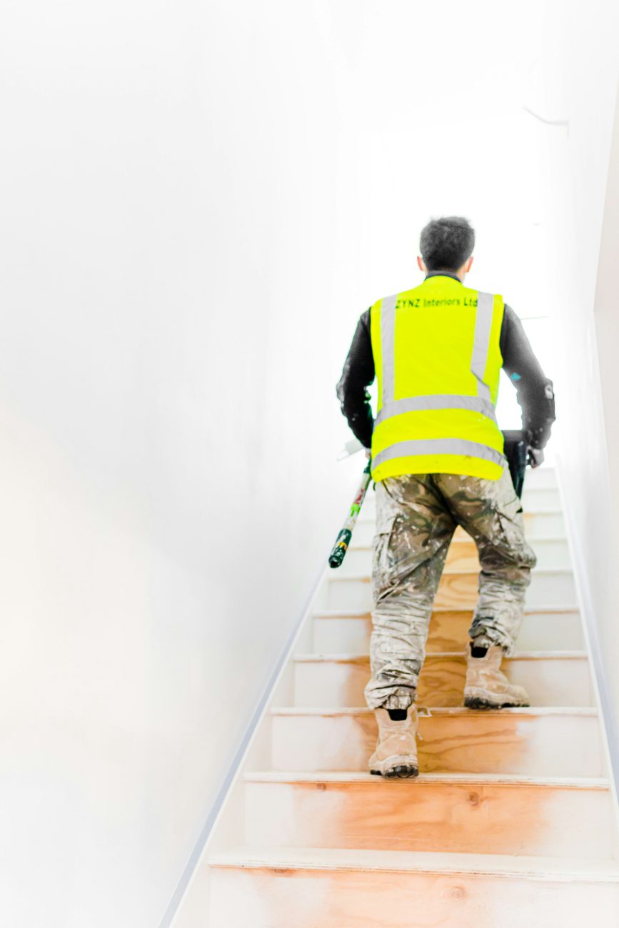 A painter completing an interior repaint during a property turnover